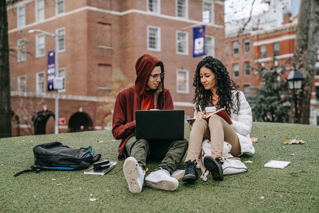 Two students studying for the LNAT exam on campus.