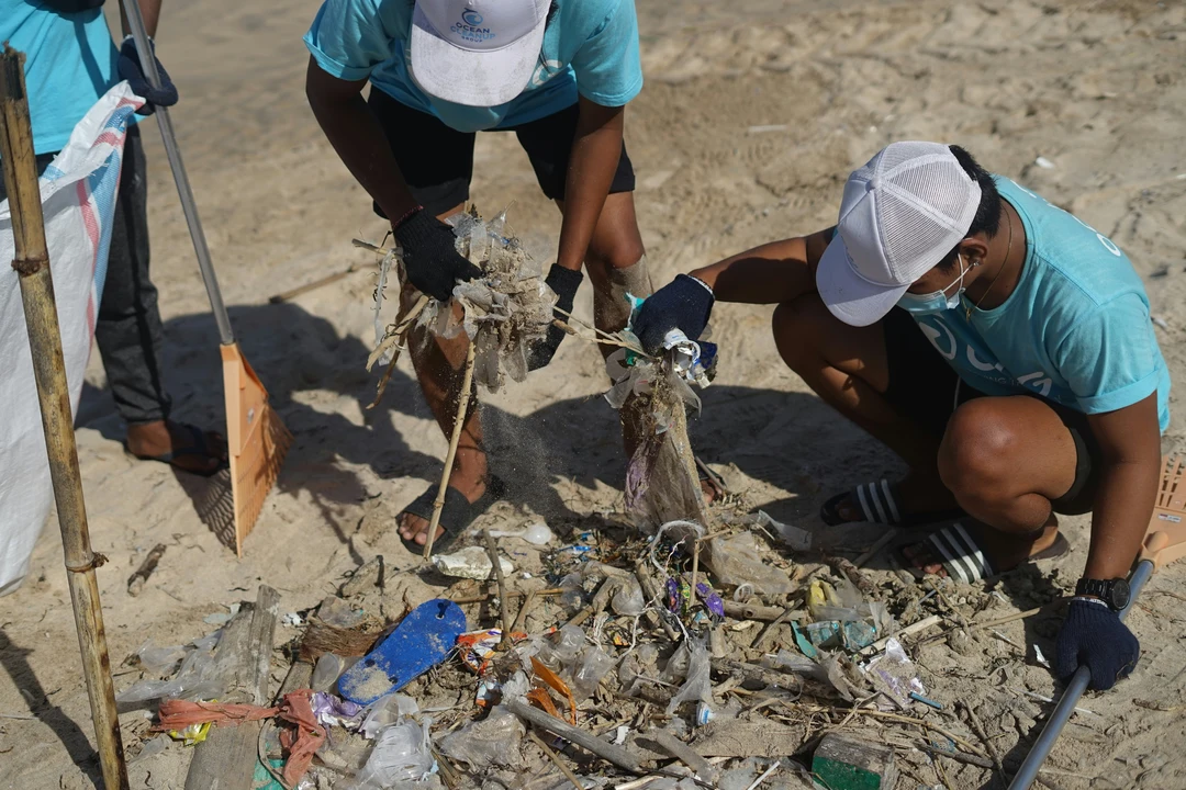 Group of teenagers participating in a beach clean-up