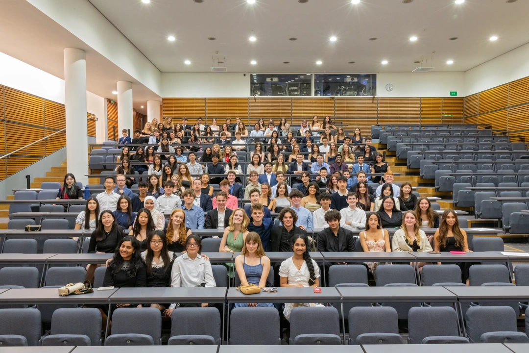 Wide shot of a lecture hall filled with students